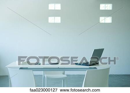 Laptop computer and cell phone on desk in office View Large Photo Image Stock Photo - Laptop computer and cell phone on desk in office. Fotosearch