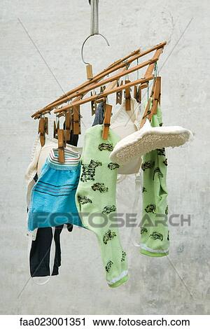 Stock Image - Laundry drying, hanging from small rack. Fotosearch