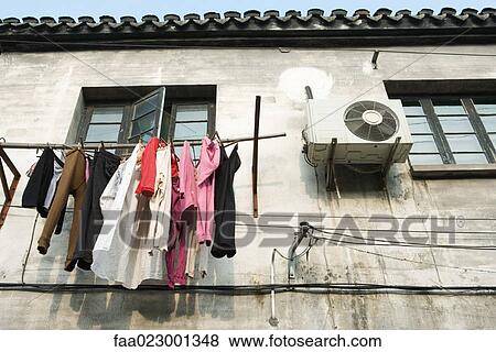 Laundry hanging out to dry below window, low angle view View Large Photo Image Stock Photo - Laundry hanging out to dry below window, low angle view. Fotosearch
