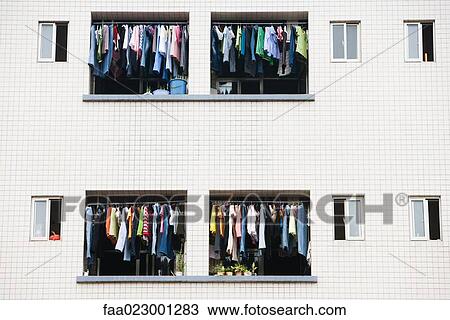 Laundry hanging to dry in balconies of apartment building View Large Photo Image Stock Image - Laundry hanging to dry in balconies of apartment building. Fotosearch