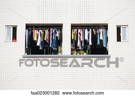 Stock Image - Laundry hanging to dry in balcony of apartment. Fotosearch