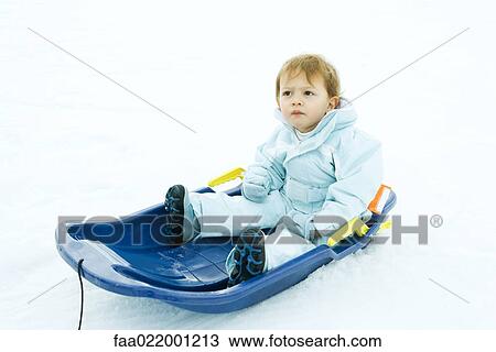 Little boy sitting on sled, looking up, frowning View Large Photo Image Stock Image - Little boy sitting on sled, looking up, frowning. Fotosearch