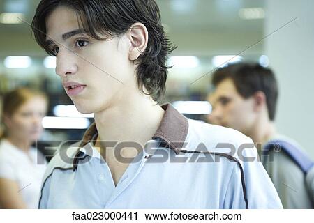 Male college student in library, looking away, head and shoulders View Large Photo Image Stock Image - Male college student in library, looking away, head and shoulders. Fotosearch