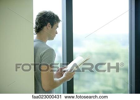 Male college student reading in library View Large Photo Image Stock Image - Male college student reading in library. Fotosearch