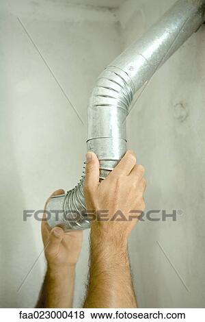 Man adjusting air duct, close-up of hands View Large Photo Image Stock Photo - Man adjusting air duct, close-up of hands. Fotosearch