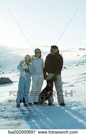 Man and two daughters standing in snow with two dogs, full length portrait View Large Photo Image Stock Photo - Man and two daughters standing in snow with two dogs, full length portrait. Fotosearch