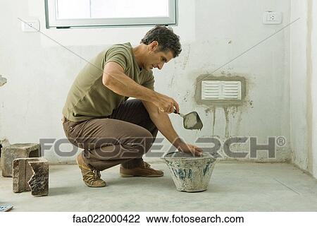 Man applying plaster around air vent View Large Photo Image Stock Image - Man applying plaster around air vent. Fotosearch