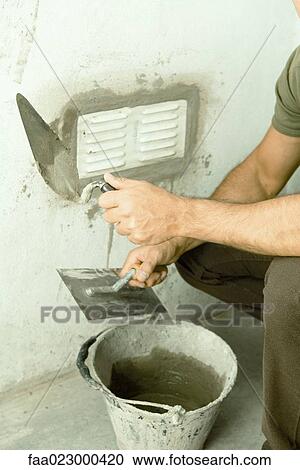 Man applying putty around air vent, cropped view View Large Photo Image Stock Image - Man applying putty around air vent, cropped view. Fotosearch