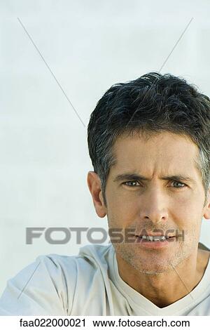 Man clenching teeth and furrowing brow, portrait View Large Photo Image Stock Image - Man clenching teeth and furrowing brow, portrait. Fotosearch