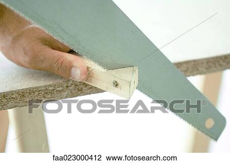 Man cutting corner off piece of wood, close-up View Large Photo Image Stock Image - Man cutting corner off piece of wood, close-up. Fotosearch