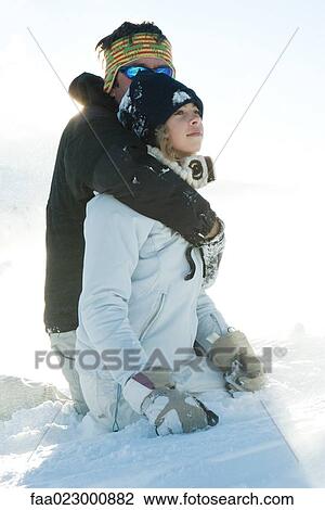 Man embracing teenage daughter, both kneeling in snow View Large Photo Image Stock Image - Man embracing teenage daughter, both kneeling in snow. Fotosearch