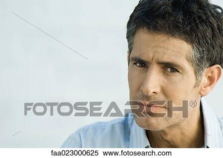 Stock Photography - Man furrowing brow, portrait. Fotosearch