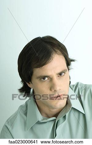 Man glaring at camera, portrait View Large Photo Image Stock Image - Man glaring at camera, portrait. Fotosearch