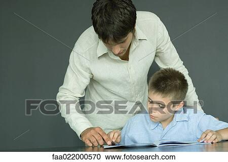 Man helping boy with homework View Large Photo Image Stock Image - Man helping boy with homework. Fotosearch