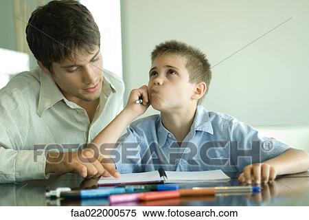 Man helping boy with homework View Large Photo Image Stock Photography - Man helping boy with homework. Fotosearch