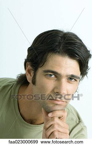 Man holding chin, looking at camera, portrait View Large Photo Image Stock Photo - Man holding chin, looking at camera, portrait. Fotosearch