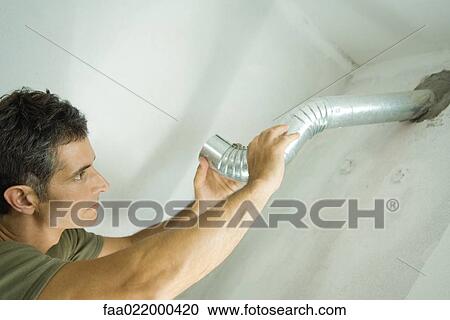 Man installing air duct View Large Photo Image Stock Image - Man installing air duct. Fotosearch