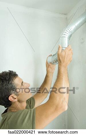 Man installing air duct View Large Photo Image Stock Image - Man installing air duct. Fotosearch