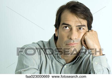 Man leaning head on hand, looking up, portrait View Large Photo Image Stock Photo - Man leaning head on hand, looking up, portrait. Fotosearch