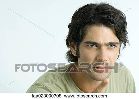 Man looking angry, pointing out of frame, portrait View Large Photo Image Stock Photo - Man looking angry, pointing out of frame, portrait. Fotosearch