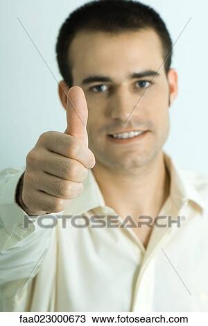 Man looking at camera, giving thumbs up sign, portrait View Large Photo Image Stock Image - Man looking at camera, giving thumbs up sign, portrait. Fotosearch