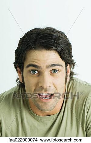 Man looking at camera, mouth open, portrait View Large Photo Image Picture - Man looking at camera, mouth open, portrait. Fotosearch