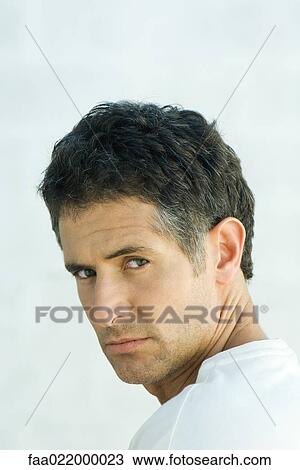 Man, looking over shoulder at camera, portrait View Large Photo Image Stock Image - Man, looking over shoulder at camera, portrait. Fotosearch