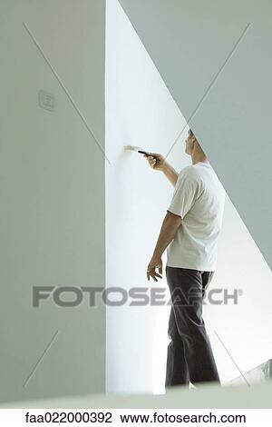 Man painting wall with paintbrush View Large Photo Image Stock Image - Man painting wall with paintbrush. Fotosearch