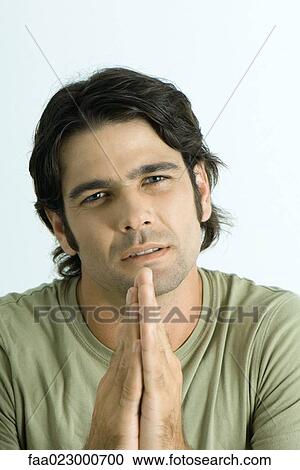 Man pleading with hands together, looking at camera, portrait View Large Photo Image Stock Image - Man pleading with hands together, looking at camera, portrait. Fotosearch