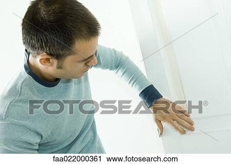 Man putting tape on door woodwork in preparation for painting View Large Photo Image Stock Image - Man putting tape on door woodwork in preparation for painting. Fotosearch