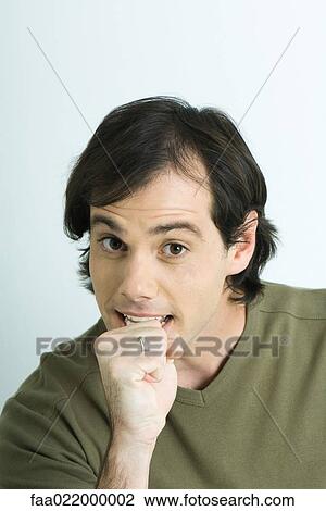 Stock Image - Man, raising eyebrows and making fist, portrait. Fotosearch