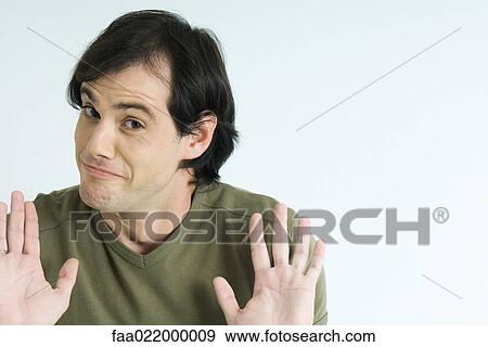 Man, raising eyebrows, holding up palms, portrait View Large Photo Image Stock Photo - Man, raising eyebrows, holding up palms, portrait. Fotosearch