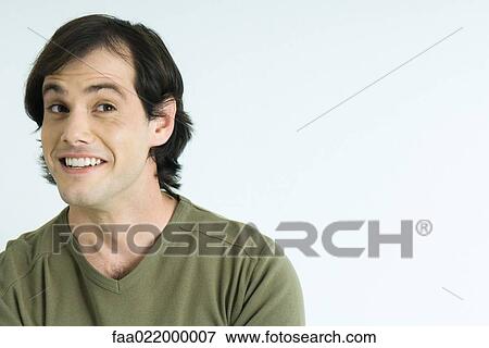 Man raising eyebrows, smiling, portrait View Large Photo Image Stock Photo - Man raising eyebrows, smiling, portrait. Fotosearch