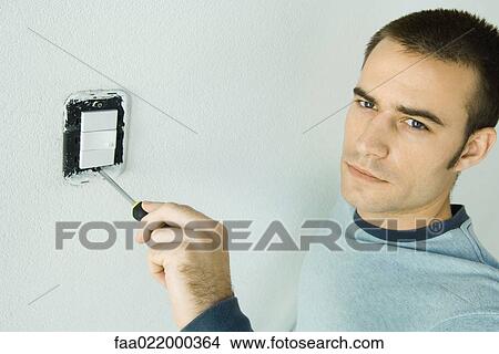 Man removing light switch cover View Large Photo Image Picture - Man removing light switch cover. Fotosearch