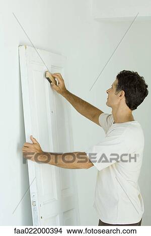 Man sanding door View Large Photo Image Picture - Man sanding door. Fotosearch