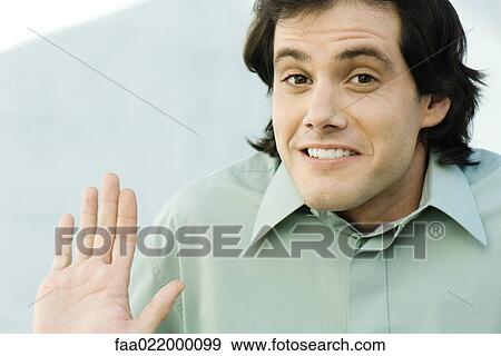 Man shrugging shoulders and holding up palm, portrait View Large Photo Image Stock Photo - Man shrugging shoulders and holding up palm, portrait. Fotosearch