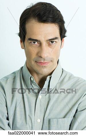 Stock Image - Man staring at camera, portrait. Fotosearch