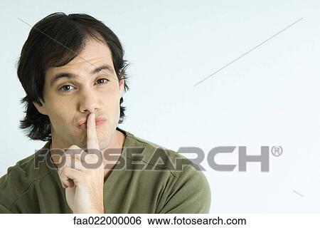 Man with finger over lips, portrait View Large Photo Image Stock Photograph - Man with finger over lips, portrait. Fotosearch