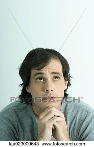 Man with hands clasped under chin, looking up, portrait View Large Photo Image Stock Image - Man with hands clasped under chin, looking up, portrait. Fotosearch