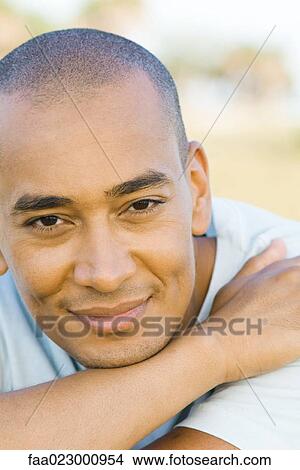 Man with shaved head smiling at camera, portrait View Large Photo Image Picture - Man with shaved head smiling at camera, portrait. Fotosearch