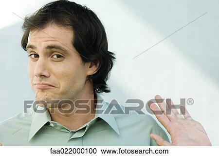 Man wrinkling chin and holding up palm, portrait View Large Photo Image Stock Image - Man wrinkling chin and holding up palm, portrait. Fotosearch