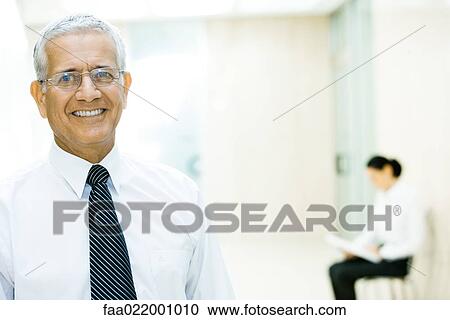 Mature businessman smiling at camera, head and shoulders, portrait View Large Photo Image Stock Image - Mature businessman smiling at camera, head and shoulders, portrait. Fotosearch