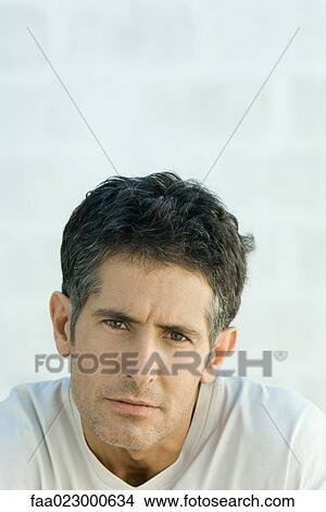 Mature man furrowing brow, looking at camera, portrait View Large Photo Image Picture - Mature man furrowing brow, looking at camera, portrait. Fotosearch