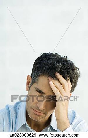 Mature man holding head, looking at camera, portrait View Large Photo Image Stock Photo - Mature man holding head, looking at camera, portrait. Fotosearch