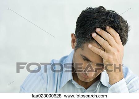 Mature man holding head, looking down View Large Photo Image Stock Photo - Mature man holding head, looking down. Fotosearch