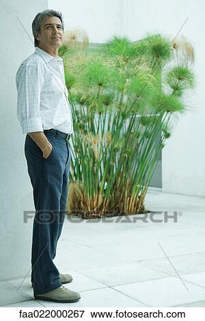 Mature man standing with hands in pockets, full length portrait View Large Photo Image Stock Photo - Mature man standing with hands in pockets, full length portrait. Fotosearch