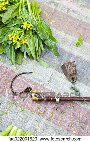 Metal hook lying on market table, close-up View Large Photo Image Stock Photo - Metal hook lying on market table, close-up. Fotosearch