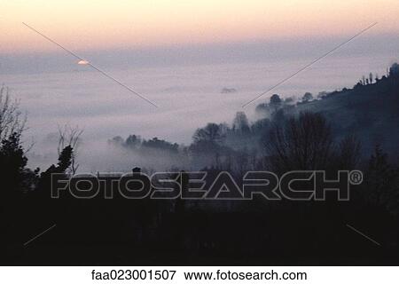 Misty valley at dawn View Large Photo Image Stock Photo - Misty valley at dawn. Fotosearch