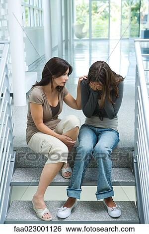 Mother comforting teenage daughter, sitting on steps View Large Photo Image Stock Photograph - Mother comforting teenage daughter, sitting on steps. Fotosearch