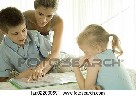 Mother helping children with homework View Large Photo Image Stock Image - Mother helping children with homework. Fotosearch